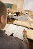 Man with papers in the classroom