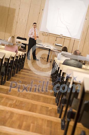 Man giving a lecture to adults Man giving a lecture to adults