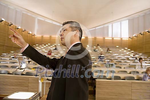 Man lecturer in front of class Man lecturer in front of class