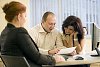 Two women and a man having a meeting