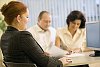 Two women and a man having a meeting