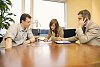 Two men and a woman having a meeting