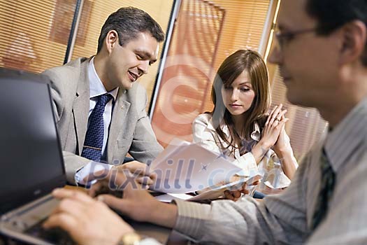 Two men and a woman in the office