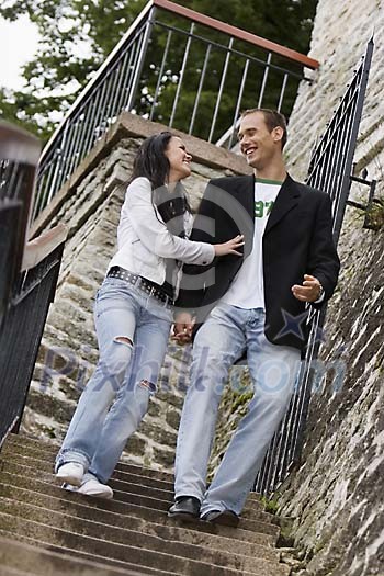 Couple coming down of the stairs Couple coming down of the stairs