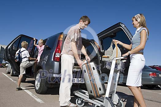 Family taking out luggage from a car Family taking out luggage from a car