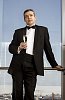 Man in tuxedo standing by the window