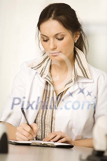 Female nurse writing Female nurse writing
