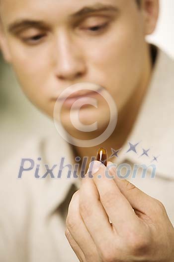 Man holding a pill Man holding a pill