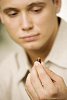 Man holding a pill