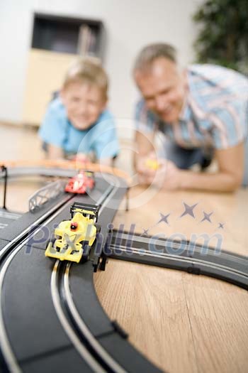 Father and son playing with cars