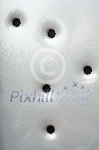 Closeup of a metal plate with holes in it Closeup of a metal plate with holes in it