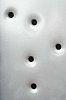 Closeup of a metal plate with holes in it