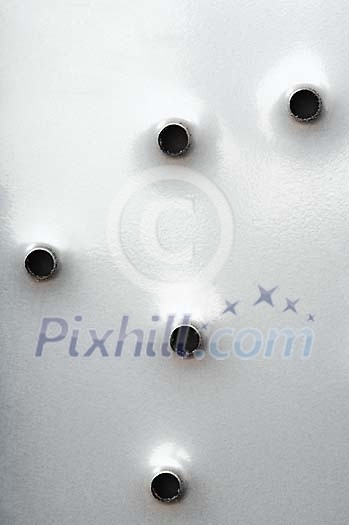 Closeup of a metal plate with holes in it Closeup of a metal plate with holes in it
