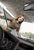 Woman cleaning her car windshield