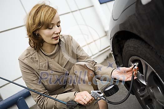 Woman checking the air pressure Woman checking the air pressure