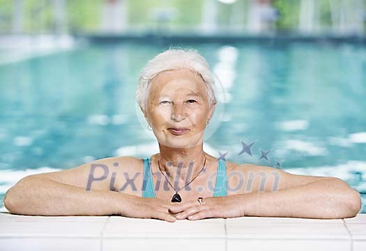 Older woman in the pool Older woman in the pool