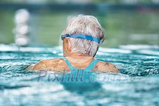 Older woman in the pool Older woman in the pool