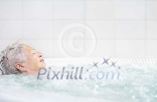 Older woman in the jacuzzi Older woman in the jacuzzi