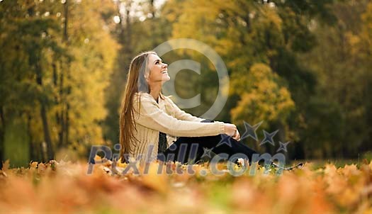 Woman sittin on the ground in the park Woman sittin on the ground in the park