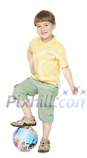 Boy standing one foot on the ball Boy standing one foot on the ball