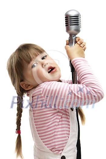 Young girl trying to reach the microphone Young girl trying to reach the microphone