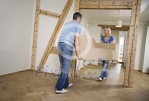 Man and woman carrying a couch Man and woman carrying a couch