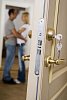 Couple standing behind an open door