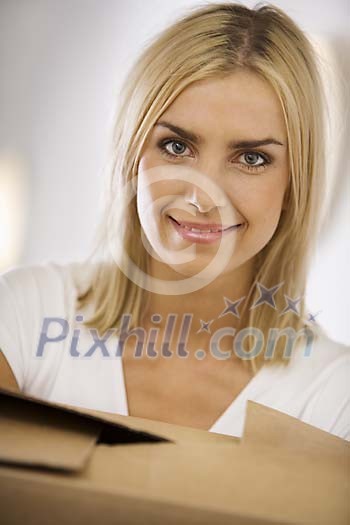 Portrait of a woman carrying a box Portrait of a woman carrying a box