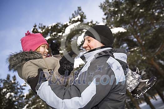 Man and child outside in the snow Man and child outside in the snow