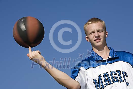 Boy spinning the ball on the finger Boy spinning the ball on the finger