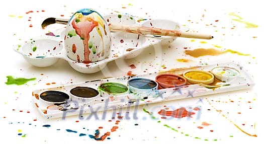 Splashed paint with egg and painting palette Splashed paint with egg and painting palette