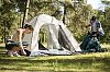 Couple in the woods, putting up the tent