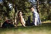 Couple sitting on the ground in the woods