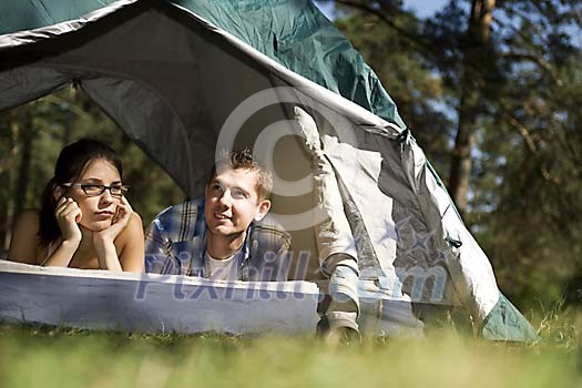 Couple looking through the tent door Couple looking through the tent door