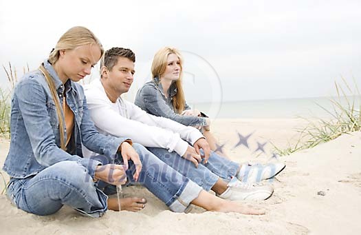 People sitting at the beach sand People sitting at the beach sand