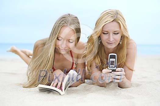 Two women relaxing at the beach Two women relaxing at the beach