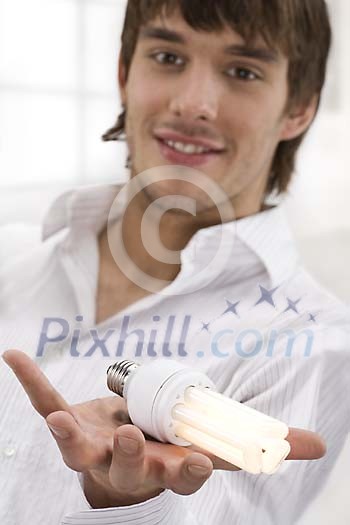 Man holding a lighted light bulb