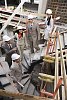 Group of people going down of the stairs at the construction site
