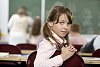 Schoolgirl looking behind in the classroom