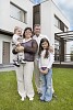 Family in front of a new house