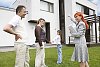 Family with real estate agent looking at a house