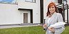 Female real estate agent in front of a house