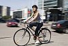 Woman biking in the city streets