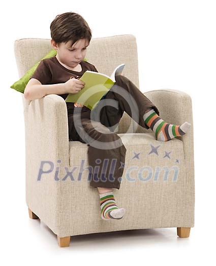 Isolated boy on the chair, reading