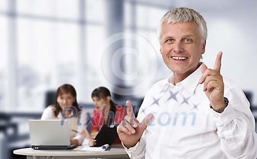 Happy male and two women in the office