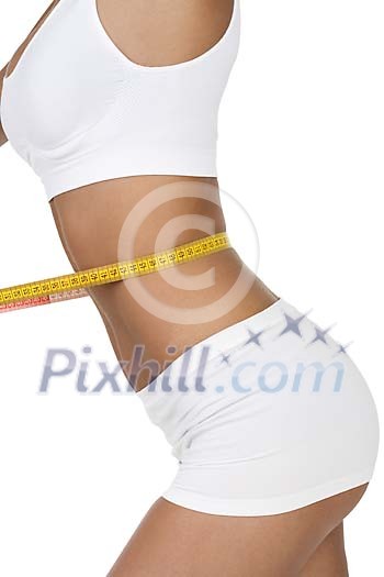 Isolated female body with a measuring tape around the waist Isolated female body with a measuring tape around the waist