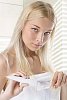 Woman in the bathroom with toothpaste and toothbrush
