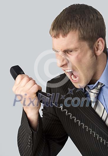 Businessman yelling to a phone Businessman yelling to a phone