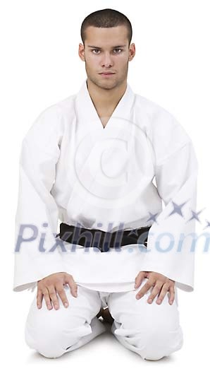 Isolated karate master sitting on the floor Isolated karate master sitting on the floor