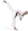 Isolated male karate master kicking